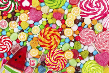 Colorful lollipops and different colored round candy.